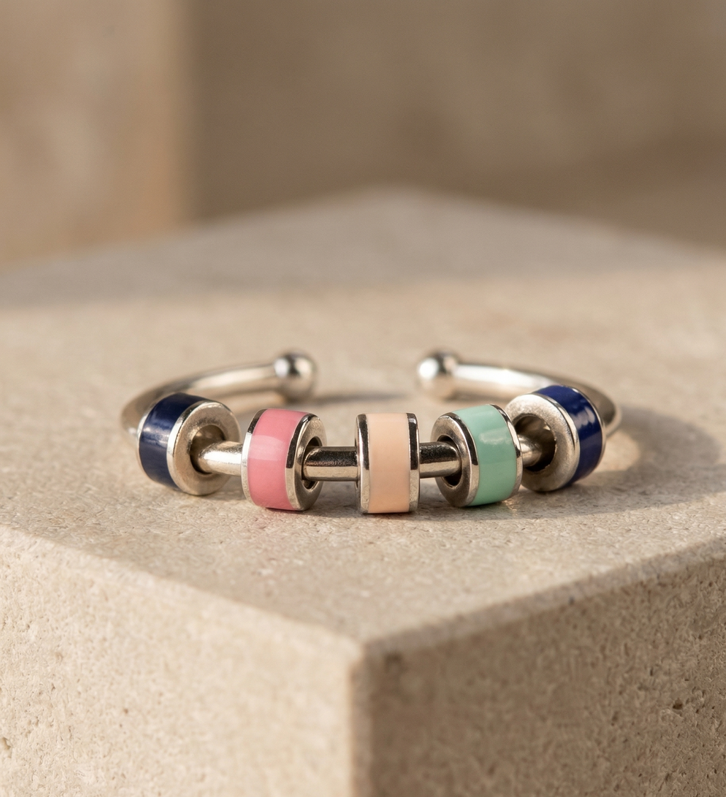 Bangle with multicolored beads on a beige surface