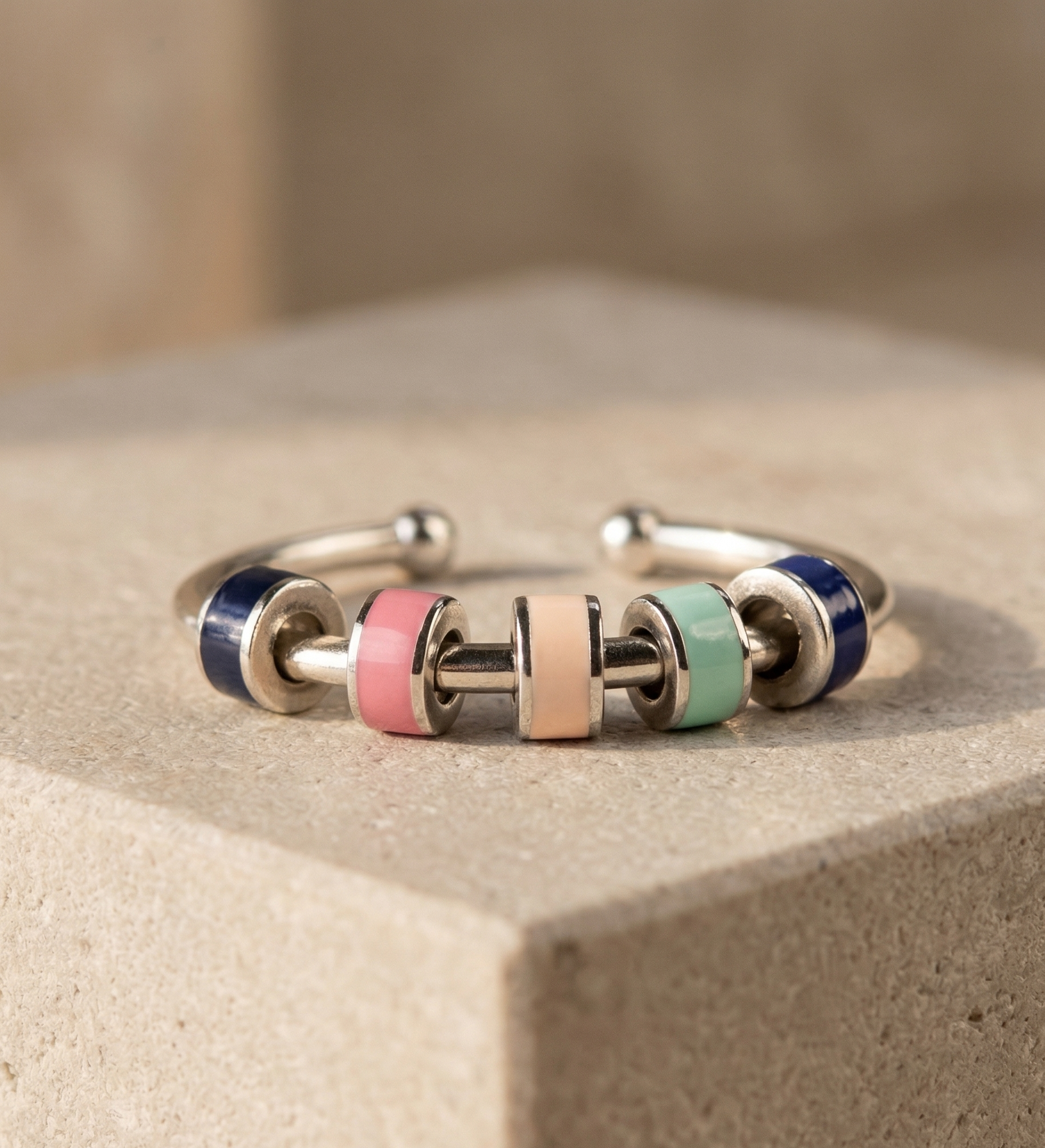 Bangle with multicolored beads on a beige surface