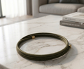 magnetic bracelet on a marble surface with books in the background