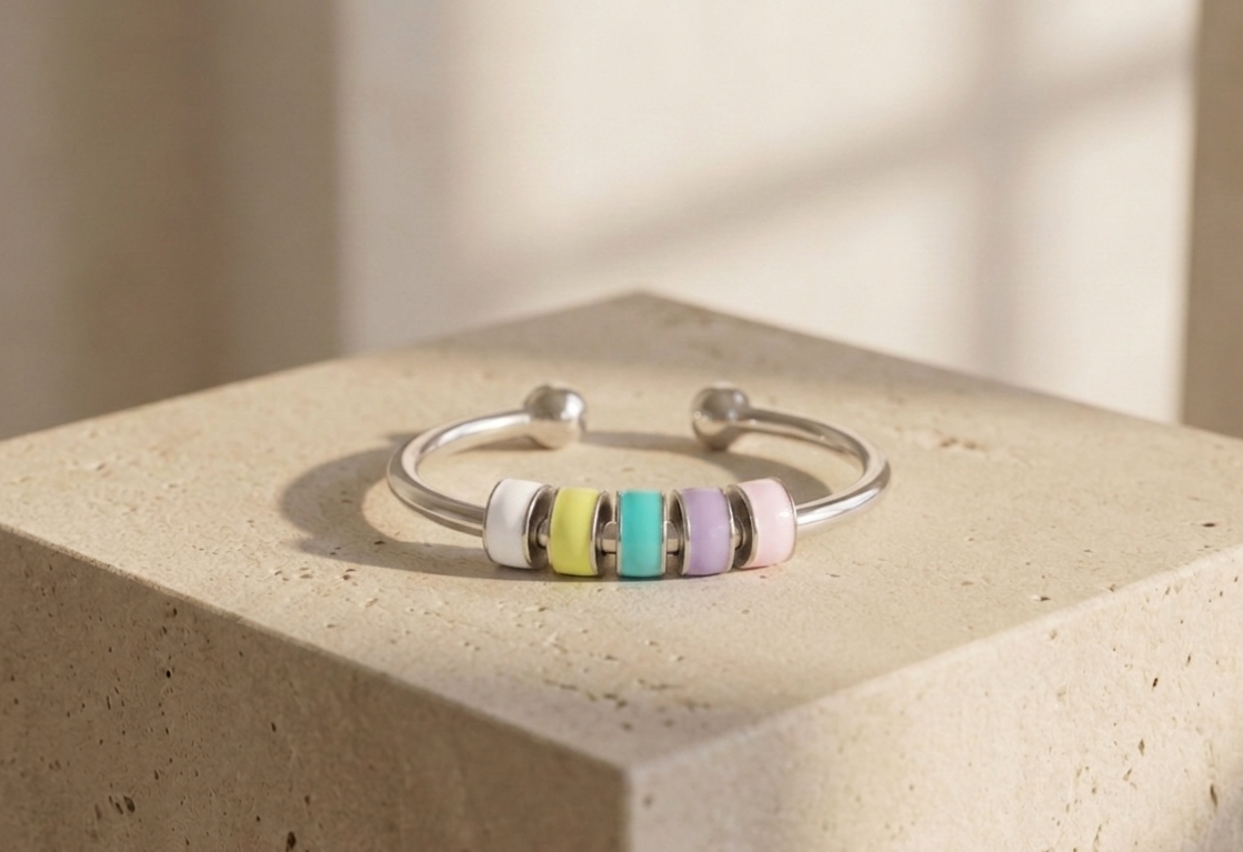 a ring with colorful enamel beads on limestone