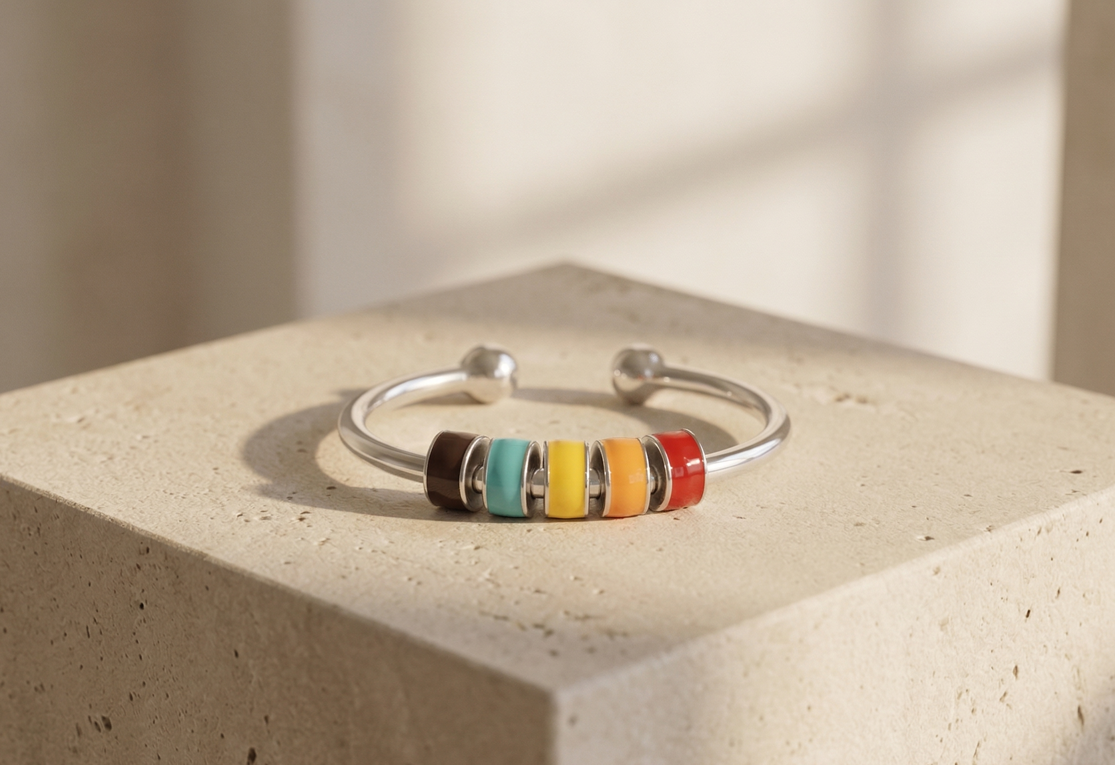 Colorful beaded ring on a concrete surface with a neutral background