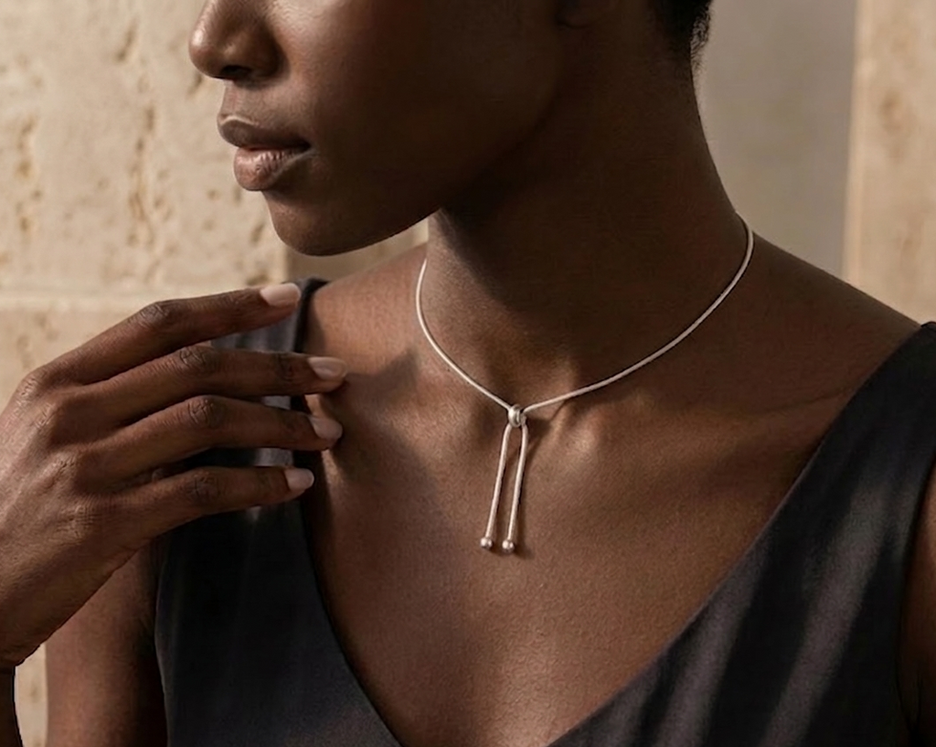 Woman wearing a necklace with a neutral background